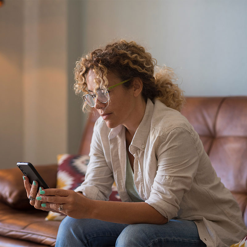 woman on couch ordering commissary for an inmate